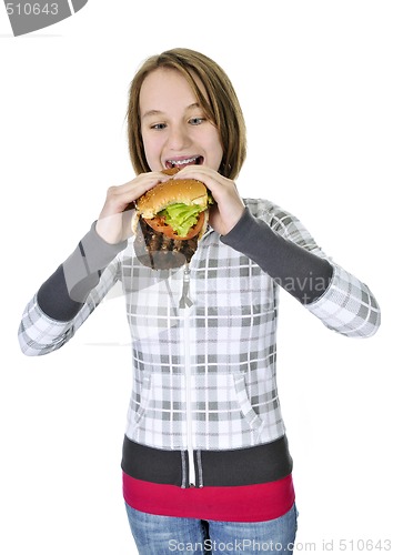 Image of Teenage girl eating big hamburger