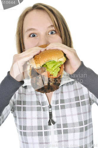 Image of Teenage girl eating big hamburger