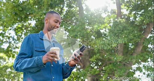 Image of Park, texting and man relax with coffee, happy and calm in nature for travel, day off and tree background. Tea, black guy and online chat while standing in forest, casual and carefree on the weekend