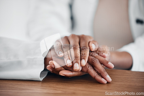 Image of Doctor, patient and holding hands for help, trust and support for medical problem, depression or cancer. hand of a healthcare person and patient talking about sad results, mental health and empathy