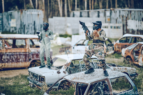 Image of Paintball, winner and soldier with gun and fist pump, victory on battlefield with military man, fitness and winning game. Sport, achievement and yes in camouflage, celebration and war win outdoor