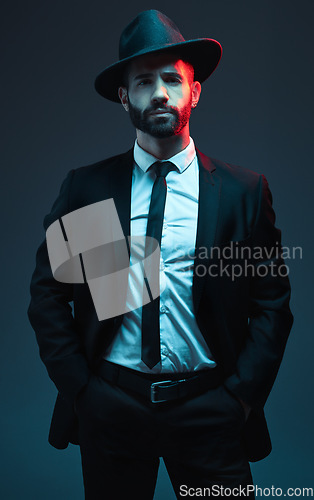 Image of Man portrait, suit or fashion on studio background in secret spy, dark isolated mafia or crime lord aesthetic. Model, gangster or serious bodyguard in stylish, trendy or tuxedo clothes in leadership