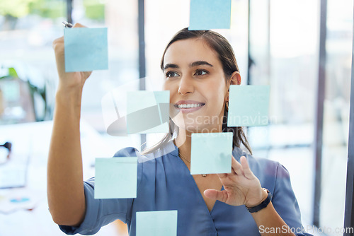 Image of Business woman, brainstorming and planning schedule for goals, agenda and vision on office window. Happy young worker writing solution, sticky note ideas and strategy for company in startup agency