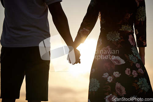 Image of Trust, love and couple holding hands in support of marriage, commitment and unity on sunset. Man, woman and people in solidarity of respect, empathy and care for hope in silhouette on Valentines Day