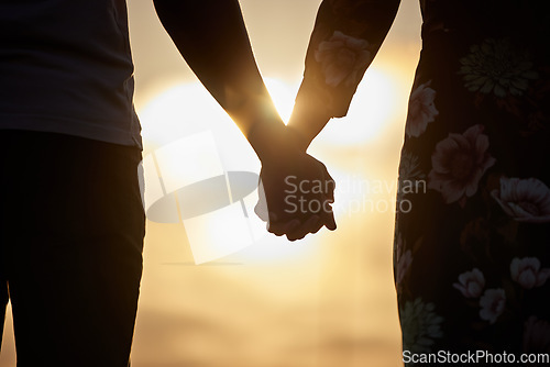 Image of Holding hands, love and trust by couple in support of marriage, commitment or unity at sunset. Man, woman and silhouette in solidarity of respect, empathy and care while united on Valentines Day