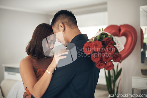 Image of Love, roses and valentines day with a couple hugging in their home, in celebration of romance. Dating, flowering boquet or surprise with a man and woman in a house to hug while bonding in intimacy