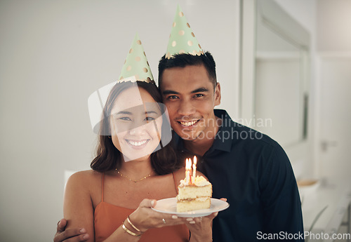 Image of Portrait, birthday cake and happy with a couple in their home, holding dessert for celebration in party hats. Love, candle or romance with a young man and woman celebrating together in their house