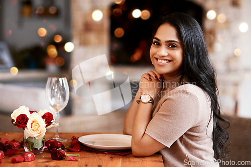 Image of Indian woman, restaurant smile and portrait of young person ready for a romantic date. Bokeh lights, fine dining and female with a glass and happiness for anniversary or valentines day feeling relax