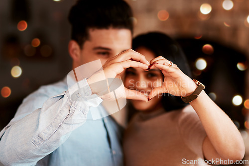 Image of Love, heart and couple in restaurant, happiness and bonding on Valentines day, affection and loving together. Romance, hand sign and man with woman, romantic and celebration for relationship and date