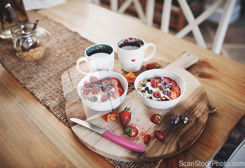 Image of Breakfast, muesli cereal and diet above on table of fruit, wheat or oats and organic food for wellness or at home. Bowls in brunch prepared with cup of coffee for dieting plan, nutrition or fibre