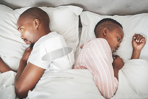 Image of Insomnia, stress and black couple in bed, angry argument about relationship, sad breakup or divorce in apartment. Mental health, depression and toxic marriage, woman ignoring man in bedroom in home.