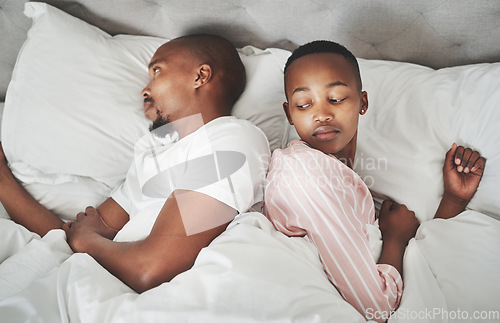 Image of Fight, marriage and black couple in bed angry from fight in bedroom feeling frustrated from conflict. Woman, man and anger of people in a home with sleeping problem from divorce or seperation