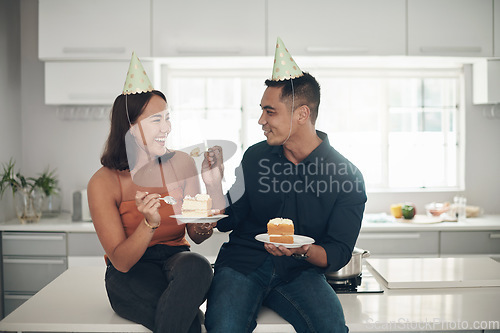 Image of Birthday cake, celebration and couple in a kitchen, happy and relax while bonding in their home, smile and laugh. Party, people and man with woman on counter for eating, fun and celebrating in Japan