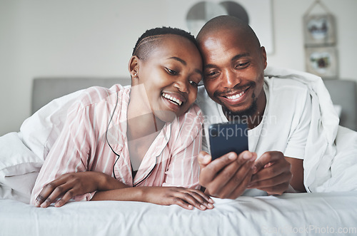 Image of Phone, contact and morning with a black couple in bed together to relax in the bedroom of their home. Mobile, meme or social media with a man and woman browsing the internet while relaxing or bonding