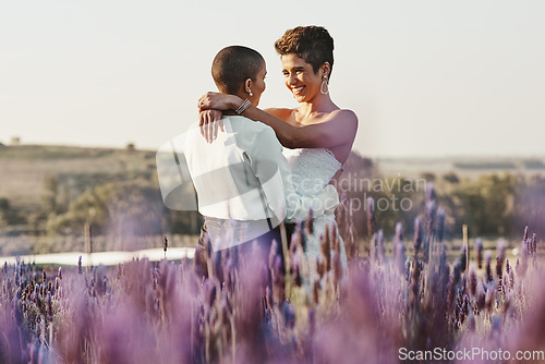 Image of Woman, lesbian couple and hug in embrace for LGBT relationship, wedding or marriage commitment in nature. Happy gay married women hugging, smiling and enjoying romantic celebration in the countryside