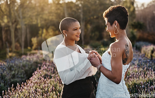 Image of Woman, lesbian couple and holding hands in marriage for wedding with smile for LGBT relationship in nature. Happy gay married women touching hand and smiling for romance, vow or loyalty outside