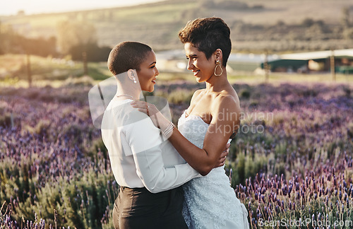 Image of Woman, lesbian couple and hug with smile for wedding, marriage or commitment in pride and support for LGBT in nature. Happy gay married women hugging, smiling and enjoying celebration in love outside