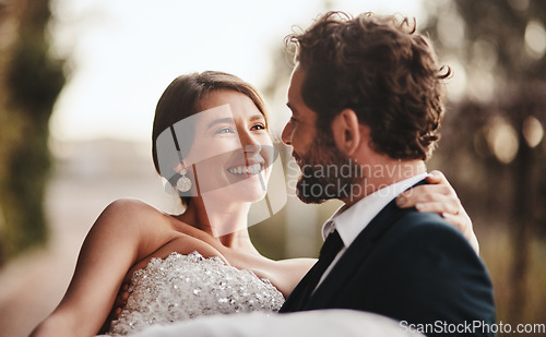 Image of Couple, love and bonding at wedding, marriage event or ceremony vows, union or commitment in sunset nature park. Smile, happy and groom carrying bride in celebration, security or partnership support