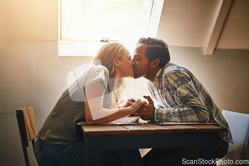 Image of Couple, love kiss and holding hands at restaurant, intimacy or bonding together at table. Valentines day, romance diversity and affection, kissing and care of man and woman enjoying date time at cafe