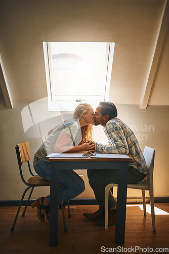 Image of Holding hands, love kiss and couple at restaurant, having fun or bonding at table. Valentines day, romance diversity or affection, kissing or care of man and woman enjoying romantic date time at cafe