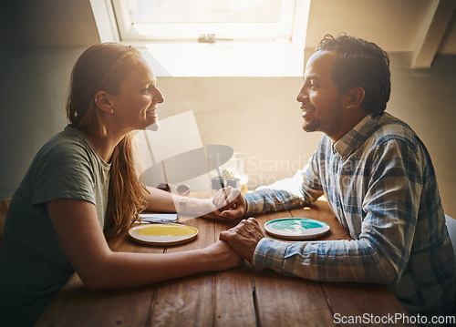 Image of Love, couple and holding hands at cafe on table, talking and bonding together. Valentines day, romance diversity and affection of man and woman on date, having fun or enjoying time in restaurant.