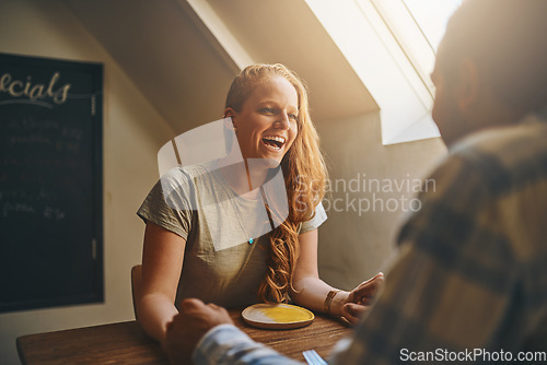 Image of Date, happy and woman laugh at joke at lunch in a cafe or restaurant enjoying quality time. Valentines day, funny and people sitting at a table in a coffee shop with love together in the morning