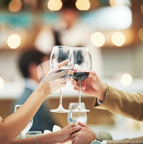 Image of Red wine, hands and date with a couple toast in a restaurant for the celebration of an anniversary. Valentines day, dating and romance with a man and woman drinking alcohol in cheers for fine dining