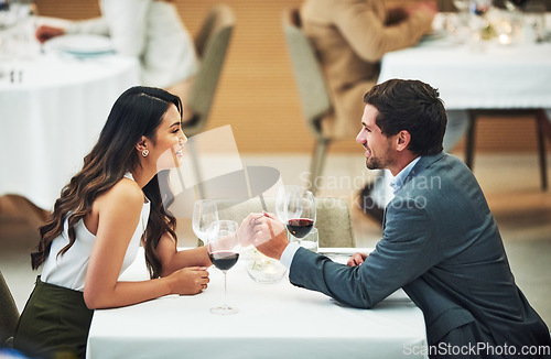 Image of Restaurant, date and couple holding hands with wine for romantic dinner, relax and anniversary celebration. Relationship, fine dining and man and woman enjoying luxury drinks, alcohol and valentines