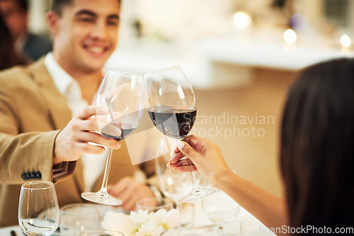 Image of Toast, wine and couple in restaurant for celebration, romantic dinner and anniversary together. Relationship, fine dining and man and woman cheers with drinks, alcohol and relax at hotel on honeymoon