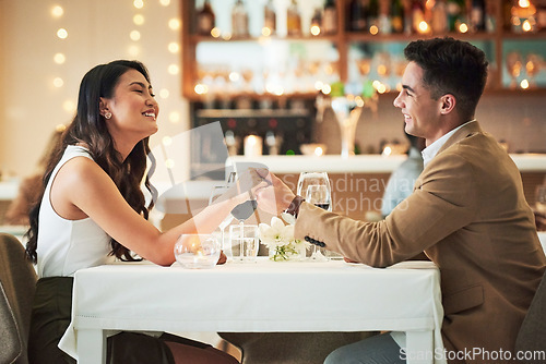 Image of Happy couple holding hands, restaurant and dinner date on Valentines day, celebrate holiday with love, care and romance. Commitment, interracial relationship and man with woman, trust and support