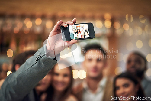 Image of Selfie, event or party group of people in restaurant for happy night celebration, mobile influencer and bokeh lights. Profile picture, hand holding and smartphone screen of friends for social media