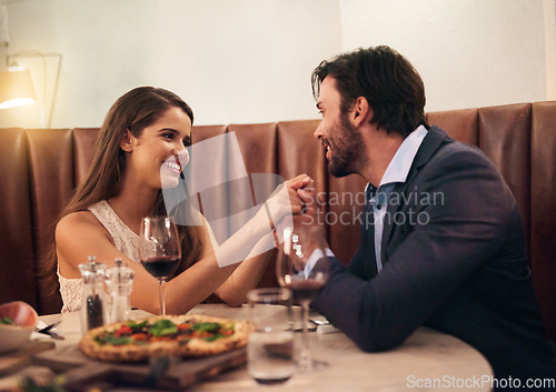 Image of Food, wine and love, couple holding hands at table on valentines day date with smile, pizza and drinks. Date night, man and woman with smile, valentine celebration and happy relationship together.