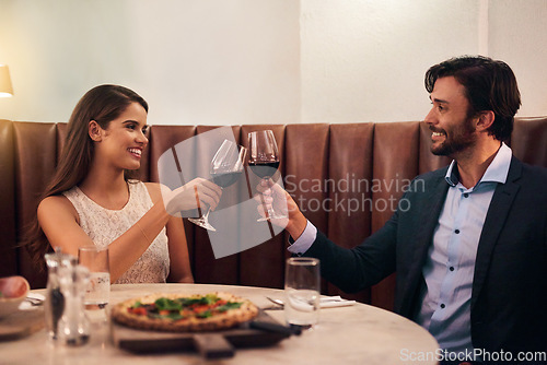 Image of Wine, cheers and valentines day with a couple in a restaurant for celebration of love, romance and fine dining. Alcohol, roast or anniversary with a young man and woman on a romantic date together