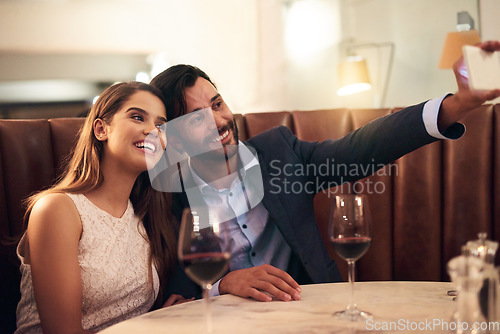 Image of Selfie, wine and anniversary with a couple in a restaurant for a romantic fine dining celebration of love. Photograph, alcohol or valentines day with a man and woman celebrating a milestone together