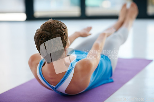 Image of Fitness, exercise and sit ups with a woman athlete training in a studio or gym for health and wellness. Workout, core and lifestyle with a young female exercising on a yoga mat to keep fit or active