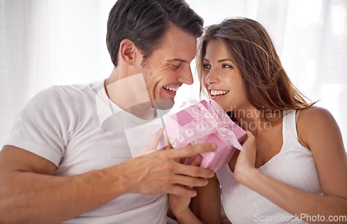 Image of Man, woman with gift box and smile, love and happiness with partnership, relationship and celebration on Valentines day. Couple with present, luxury and commitment, gratitude and celebrate holiday