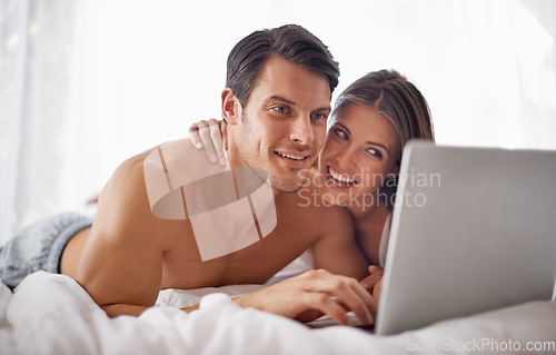 Image of Couple with laptop, streaming movie and relax at home with technology, happy and fun together with film website Love, commitment and relationship with man and woman in bedroom with subscription