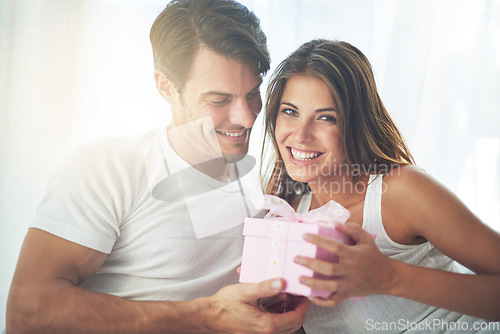 Image of Couple, gift or present for valentines day portrait celebration with love, care and surprise in bedroom. Man and woman in happy home with box for birthday, holiday or luxury with smile for gratitude
