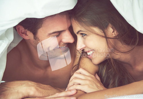 Image of Couple, happy and love in bed, waking up and bonding in a bedroom together, flirting and romantic. Romance, man and woman relax, intimate and resting at hotel for valentines day, anniversary or bond