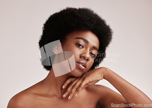 Image of Portrait, beauty or skincare and a model black woman in studio on a gray background with afro hair. Skin, cosmetics and natural with an attractive young female posing indoor for health or wellness