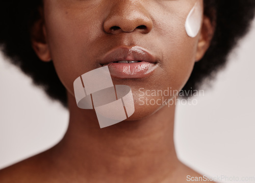 Image of Black woman, face and cream of a model with facial mask, skincare and sunscreen in studio. Isolated, white background and self care treatment of a young person with cosmetic and collagen lotion