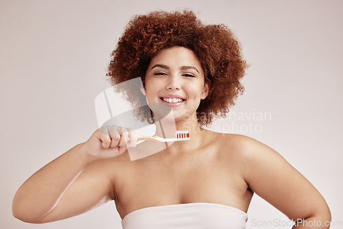 Image of Black woman, studio portrait and toothbrush for cleaning, healthy mouth and hygiene by background. Happy gen z model, brushing teeth and smile for beauty, wellness or self care with dental toothpaste