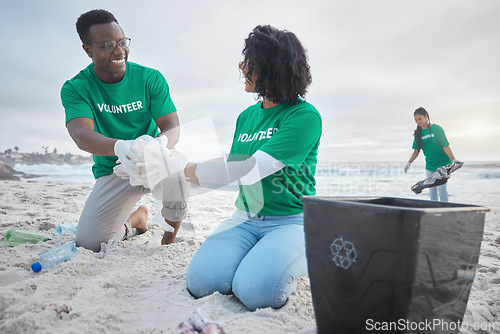 Image of Teamwork, happy and recycling with people on beach for sustainability, environment and eco friendly. Climate change, earth day and nature with volunteer and plastic for help, energy and pollution