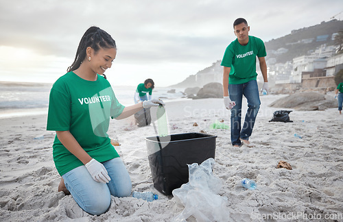 Image of Teamwork, cleaning and recycling with people on beach for sustainability, environment and eco friendly. Climate change, earth day and nature with volunteer and plastic for help, energy and pollution