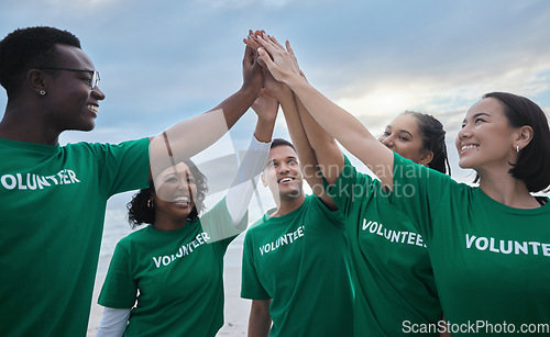 Image of Teamwork, high five and volunteer with people on beach for sustainability, environment and climate change. Charity, earth day and community with friends for support, diversity and pollution awareness