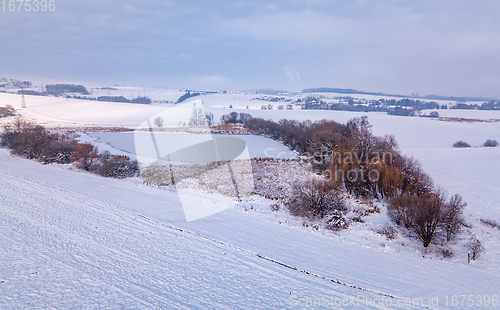 Image of Aerial bird view of beautiful winter landscape with frozen pond covered with snow. Central european countryside. Czech Republic, Vysocina Highland region, Europe