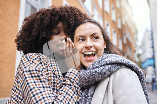 Image of Woman, friends and gossip in the city whispering in the ears for secret conversation or discussion. Happy, shocked or surprised women in private communication, announcement or secrets in the street