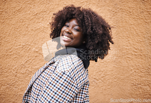 Image of Black woman, portrait and smile on wall background in city, urban town and Kenya. Happy plus size african female with natural afro, happiness and confidence outdoors with fashion, relax and freedom