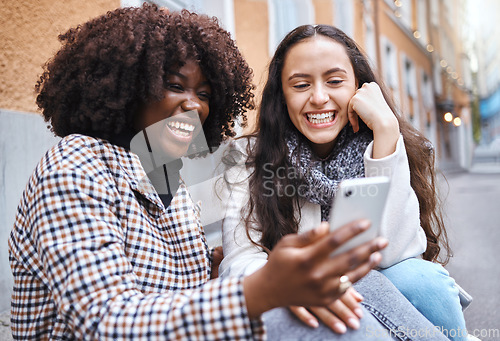 Image of Friends, city and women with phone for social media, conversation and connection on London street. Communication, internet and happy black woman and girl on smartphone smile for selfie, app and meme