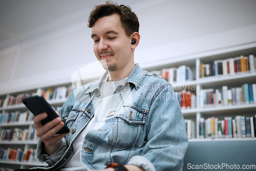 Image of Library, man and smartphone for typing, music and relax on weekend, student and connection for social media. Male, gentleman and guy with cellphone, listening to audio and podcast with smile and joy